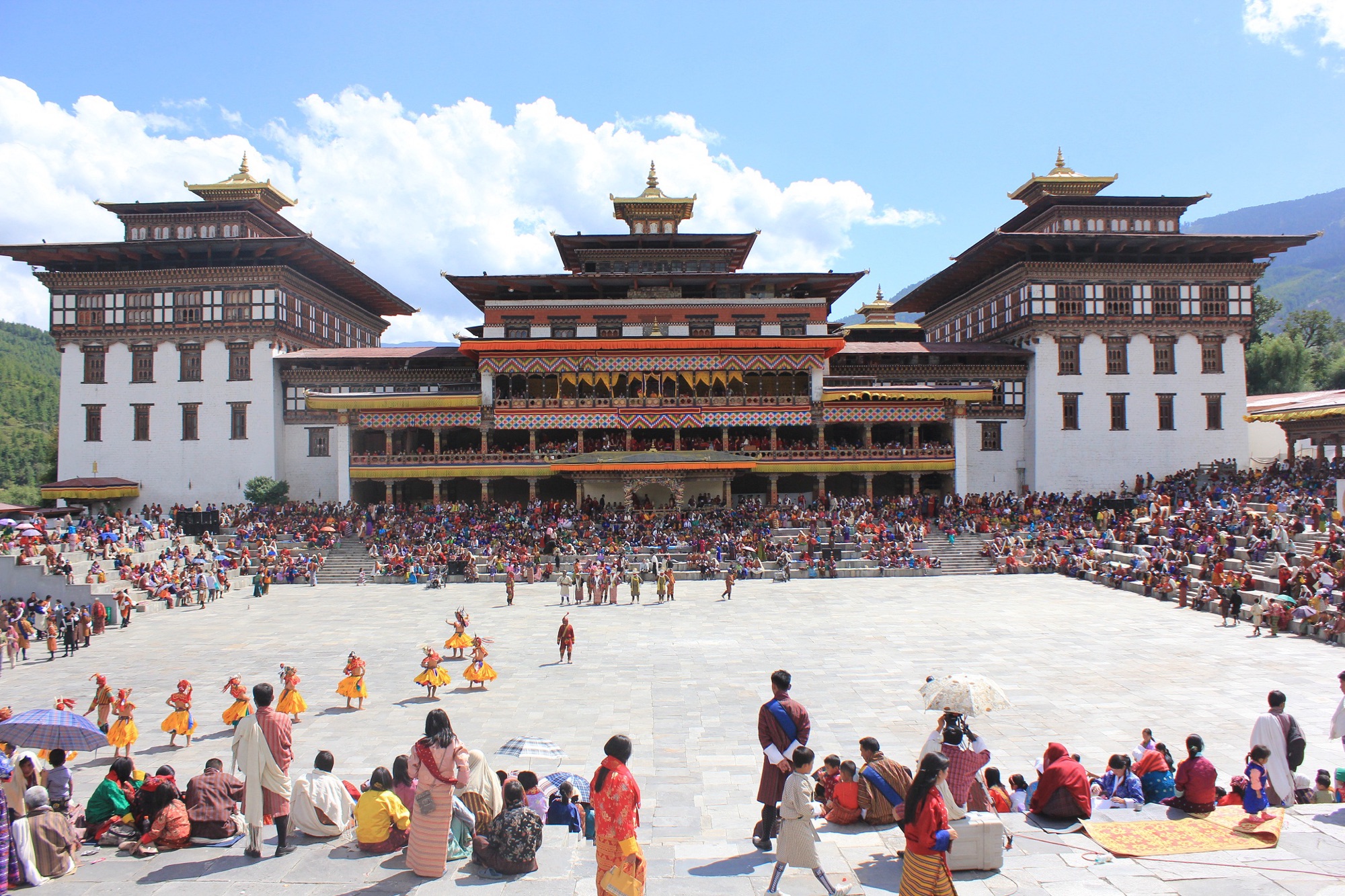Crowds in national dress at the Thimphu Tshechu, in front of Trashichhodzong