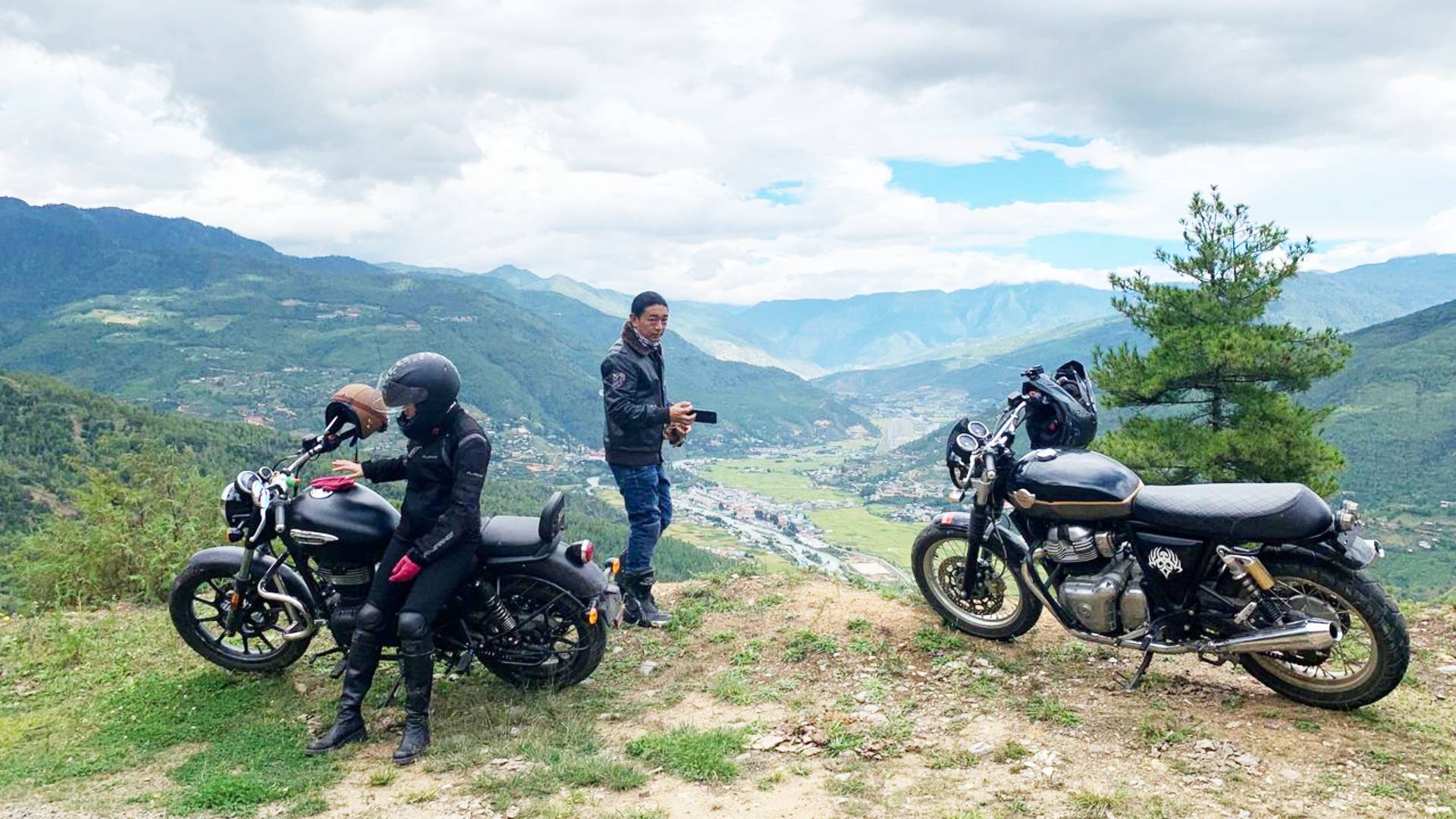 Motorcycles parked at a viewpoint in the Bhutanese hills