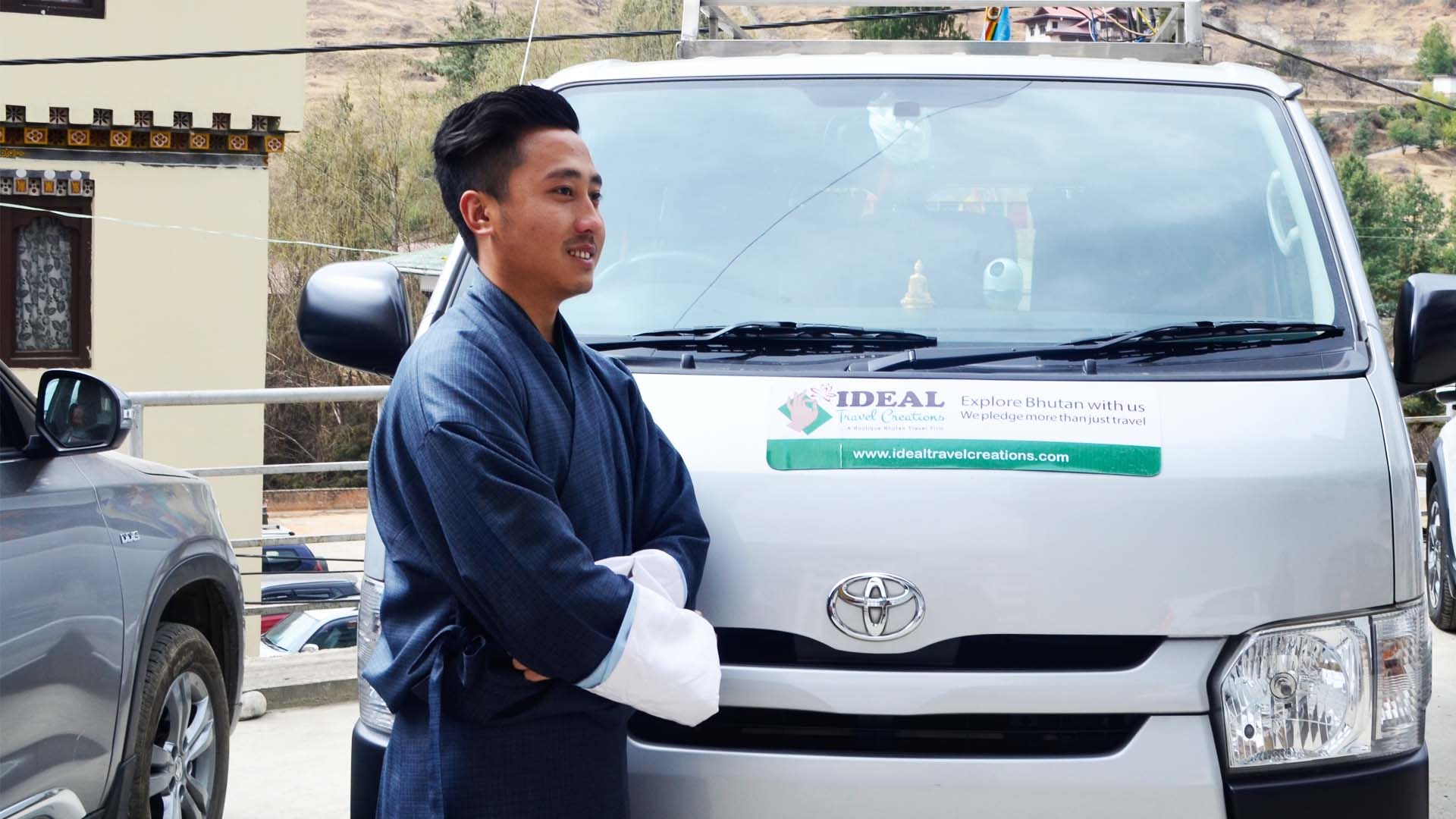 An Ideal Travel Creations driver beside the tour van